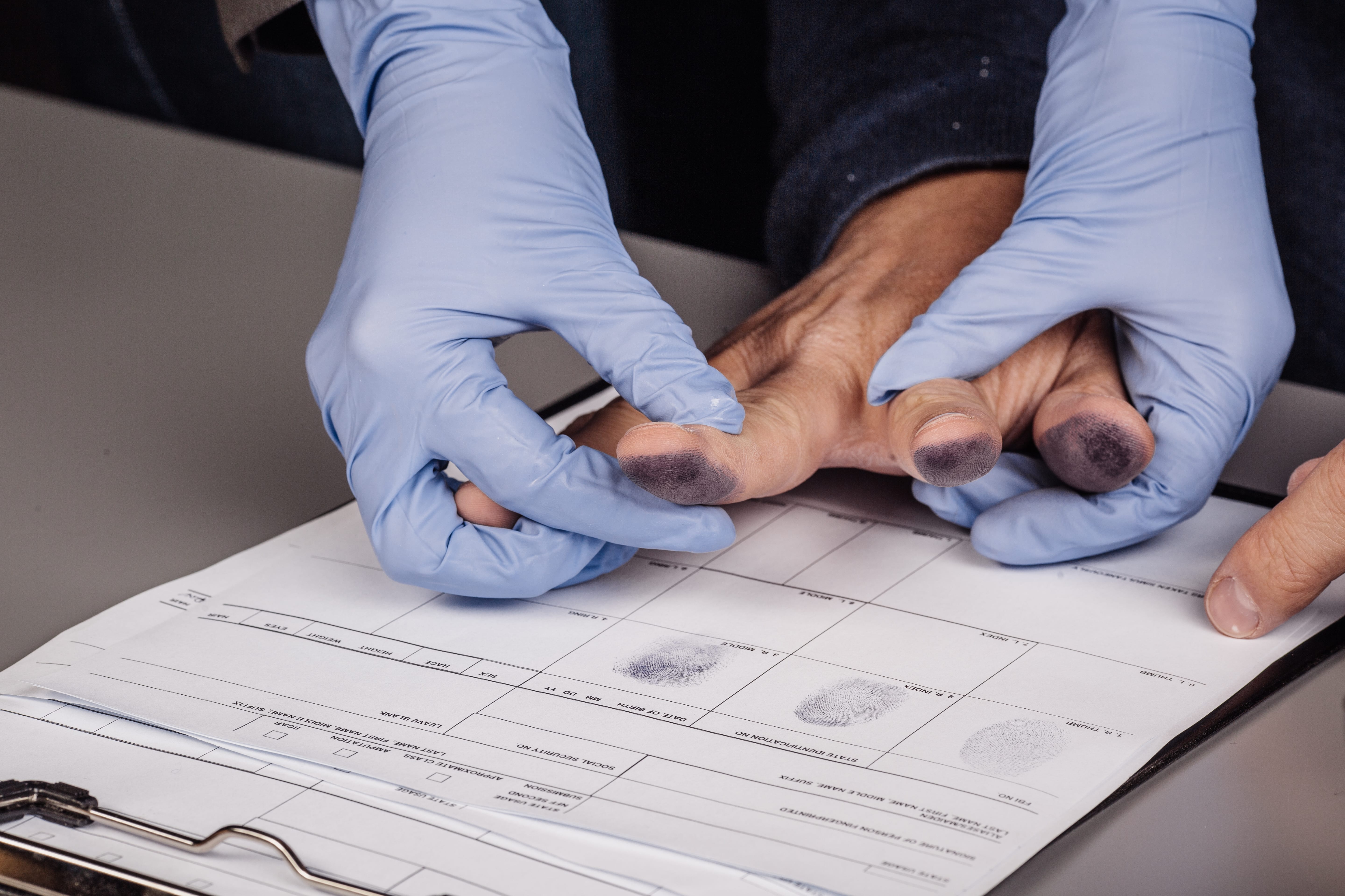criminal getting finger printed